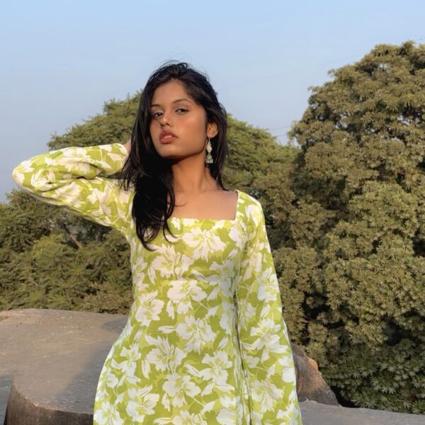 a woman standing on a rock